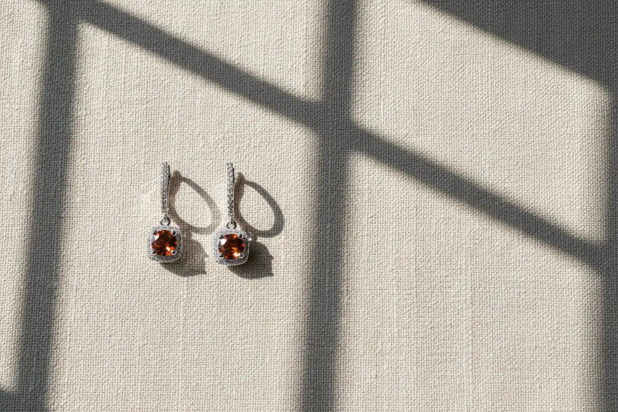 Amber Orange Drop Huggie Earrings on linen with window shadow | OriaJewel
