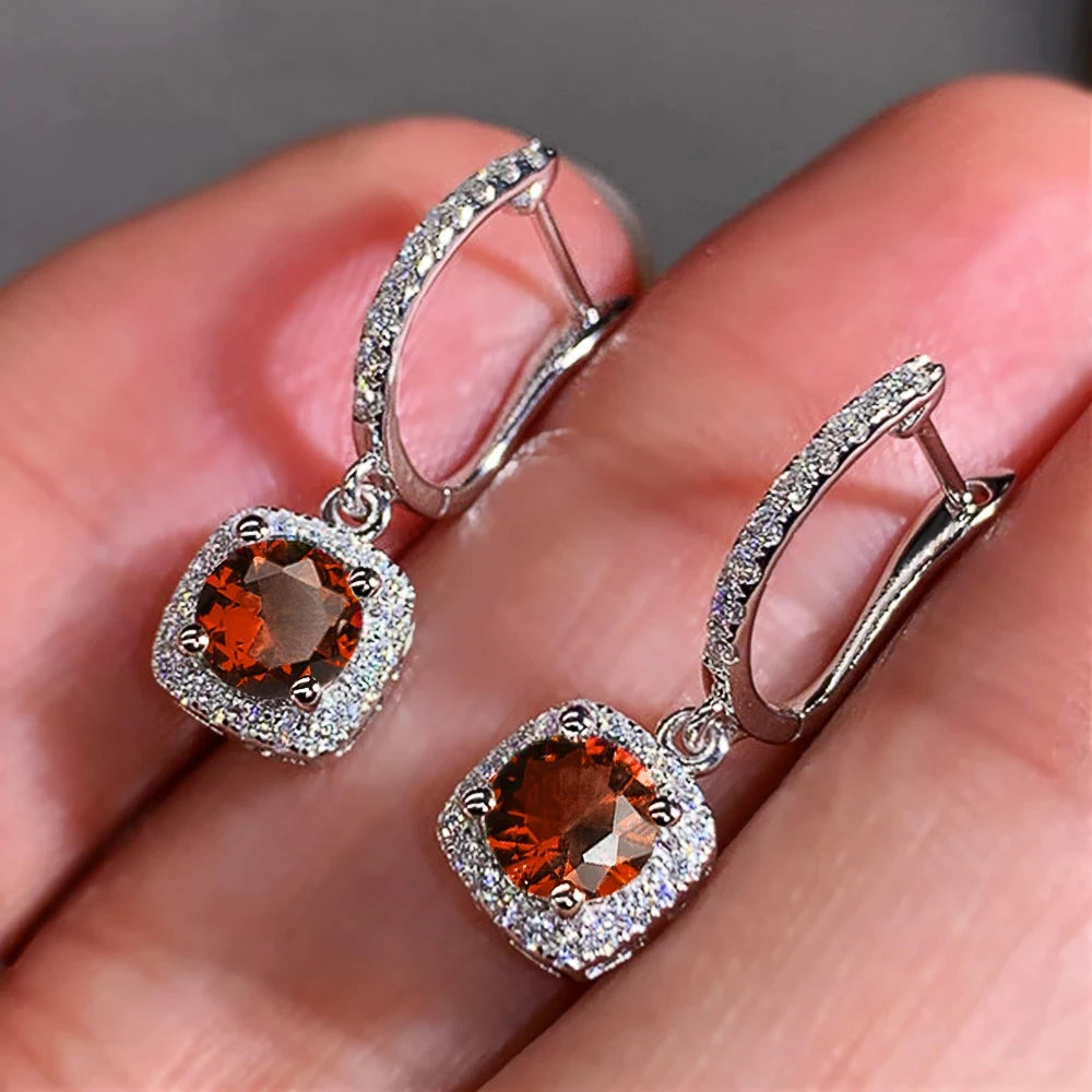 Close-up Amber Orange Drop Huggie Earrings with crystal halo | OriaJewel