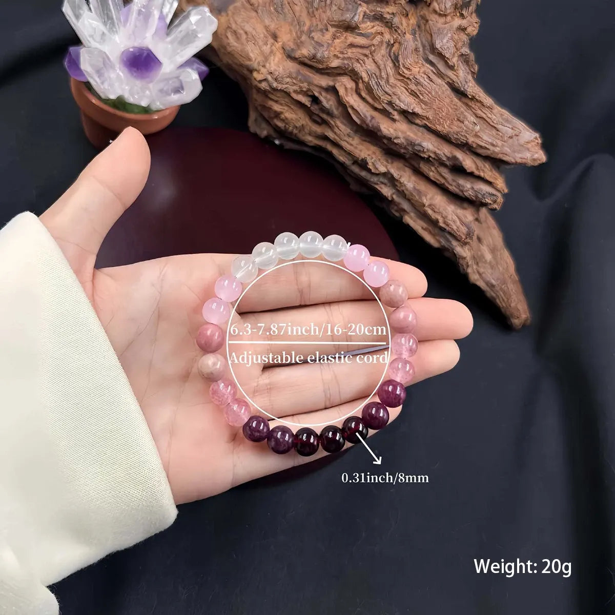 Adjustable Aurora Healing Crystal Bracelet with gradient pink and wine-red beads shown on a hand with size and weight details overlay | Oria Jewel