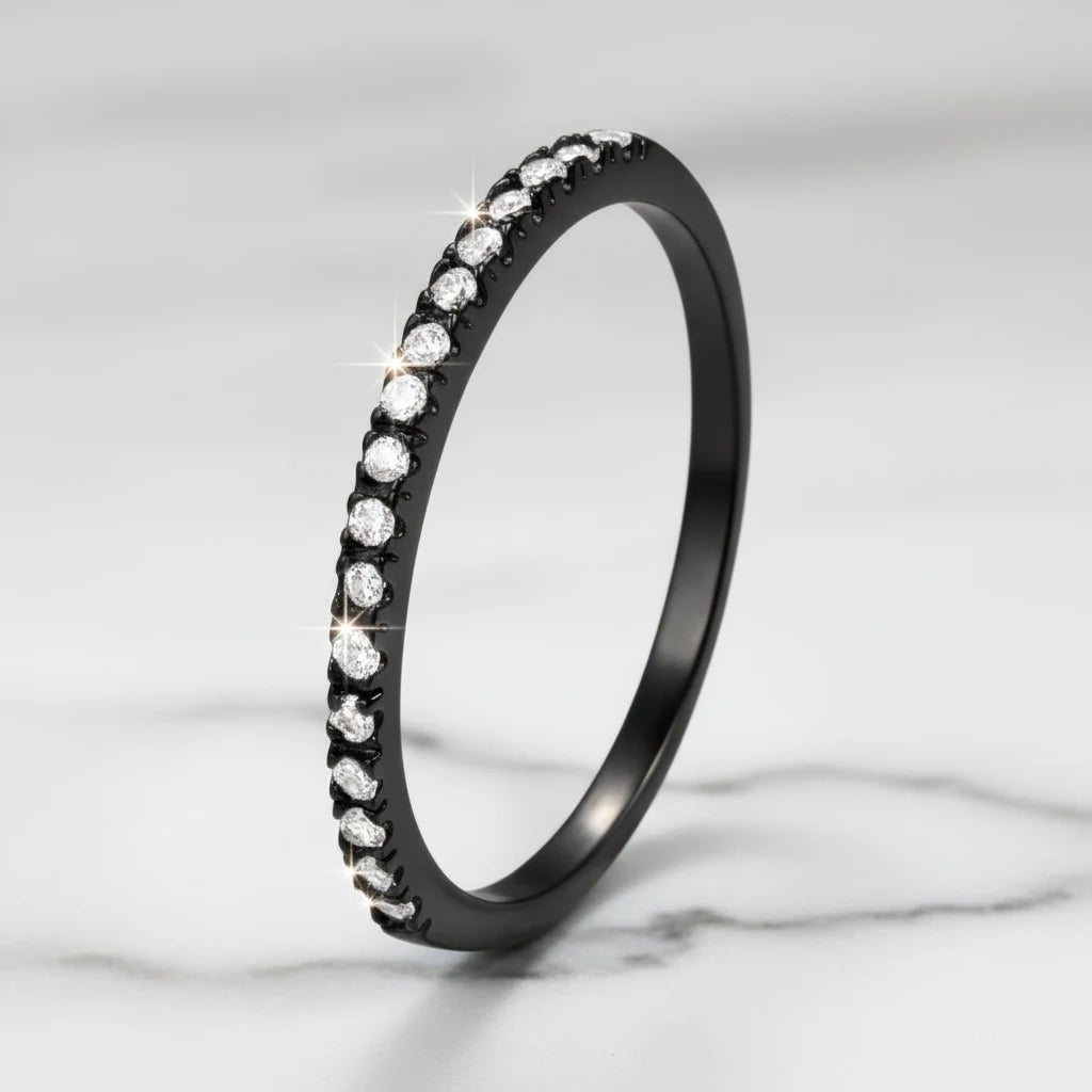 Black Midi Ring Set featured in a close-up product shot, the black pavé band standing upright on a light marble surface with crisp focus on the glittering stone row and subtle studio sparkle highlights | OriaJewel