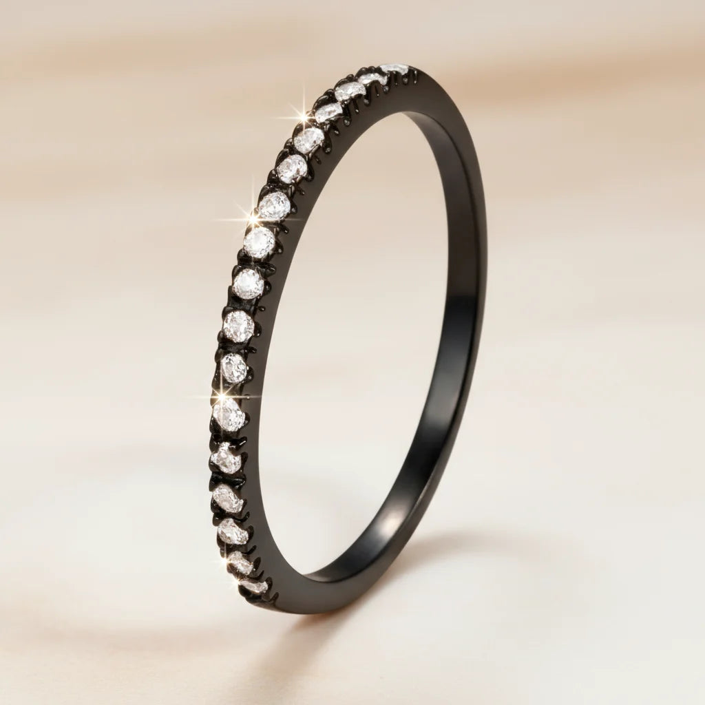 Black Midi Ring Set in a premium studio portrait, the black pavé band standing upright against a warm neutral background with gentle blur and bright sparkle accents emphasizing the stones | OriaJewel