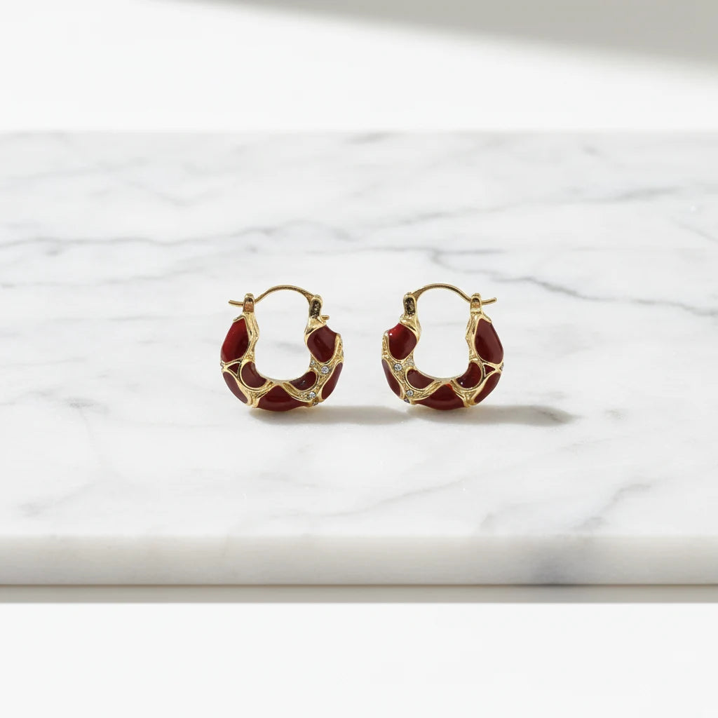 Burgundy Huggie Hoop Earrings close-up on marble background | OriaJewel