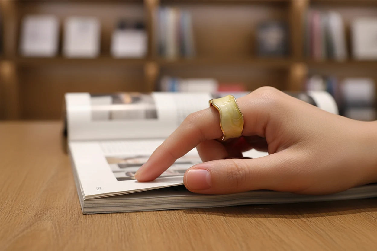 Champagne Marble Open Wave Ring on hand flipping a magazine in a library setting | OriaJewel