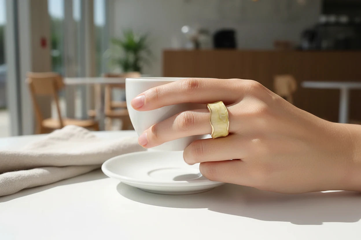 Champagne Marble Open Wave Ring on hand holding a white coffee cup in a sunlit café | OriaJewel