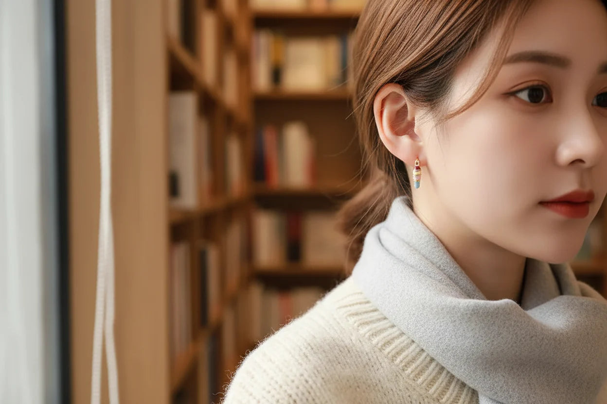 Colorful Heart Huggie Hoop Earrings worn on model in library setting | OriaJewel