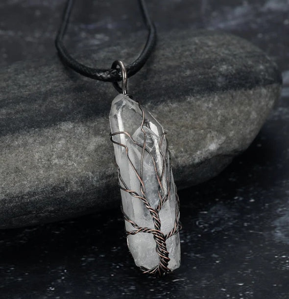 close-up of shiny crystal stone pendant reflecting light | Oria Jewel