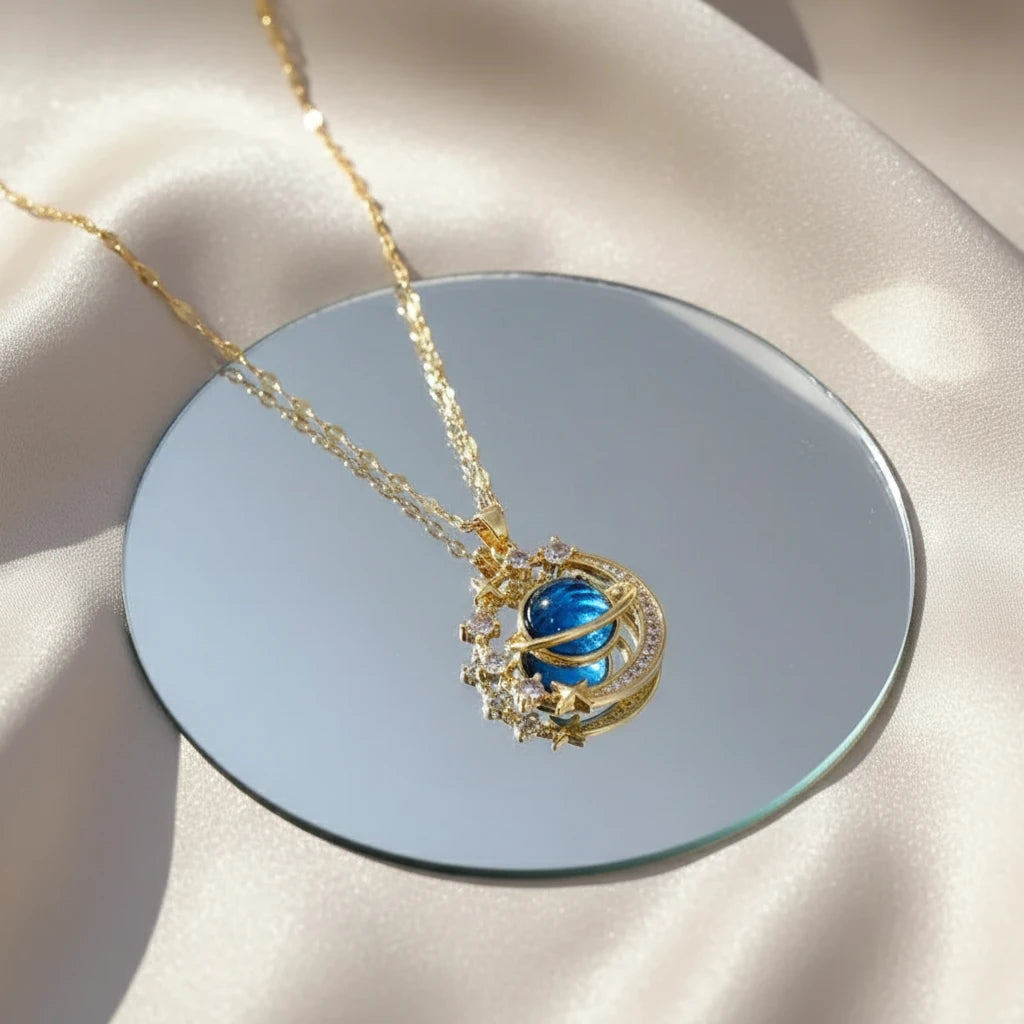 Cute Matching Couples Necklaces featuring a blue planet pendant on a golden chain reflecting on a mirror | Oria Jewel