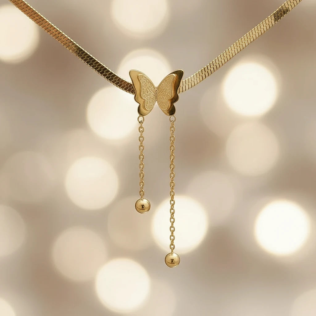Close-up of Gold Butterfly Chain Necklace showing detailed butterfly charm and dangling gold beads | Oria Jewel