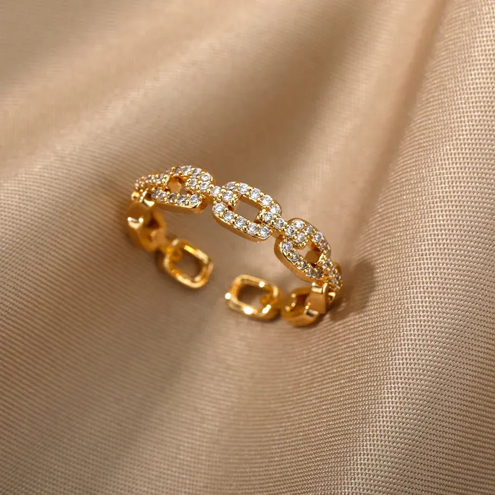 Gold Chain Link Ring on silky neutral fabric, tight shot emphasizing the textured pavé stones, bold link shape, and adjustable opening | OriaJewel