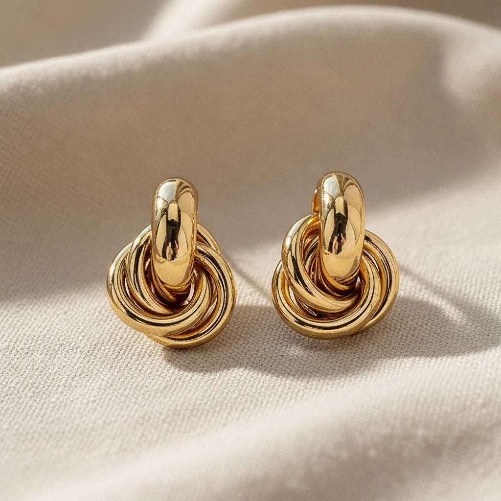 Gold Chunky Knot Stud Earrings macro on soft fabric in warm light | OriaJewel