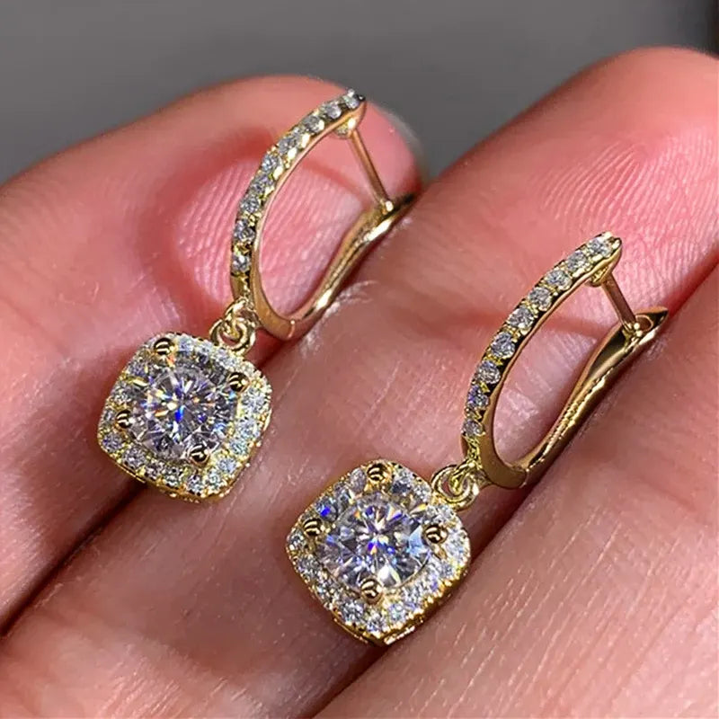 Gold Crystal Drop Huggie Earrings in-hand close-up showing hoop clasp and sparkle | OriaJewel
