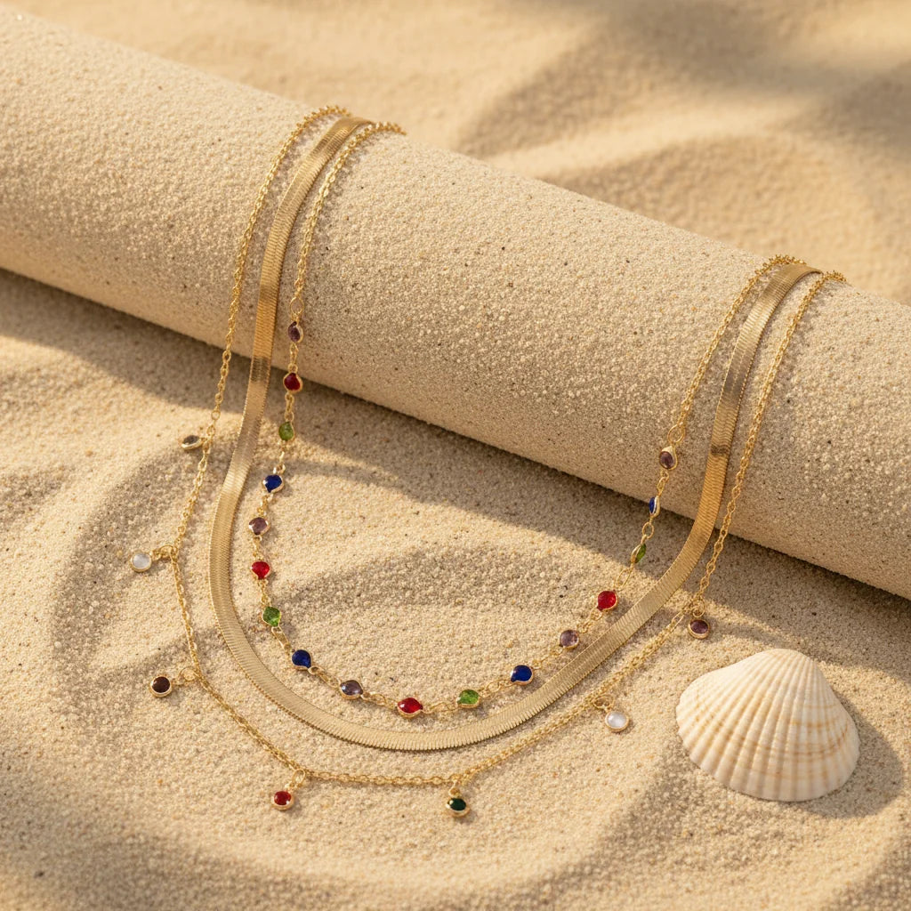 Gold Multilayer Choker Necklace with colorful gemstone accents on a sandy beach background | Oria Jewel