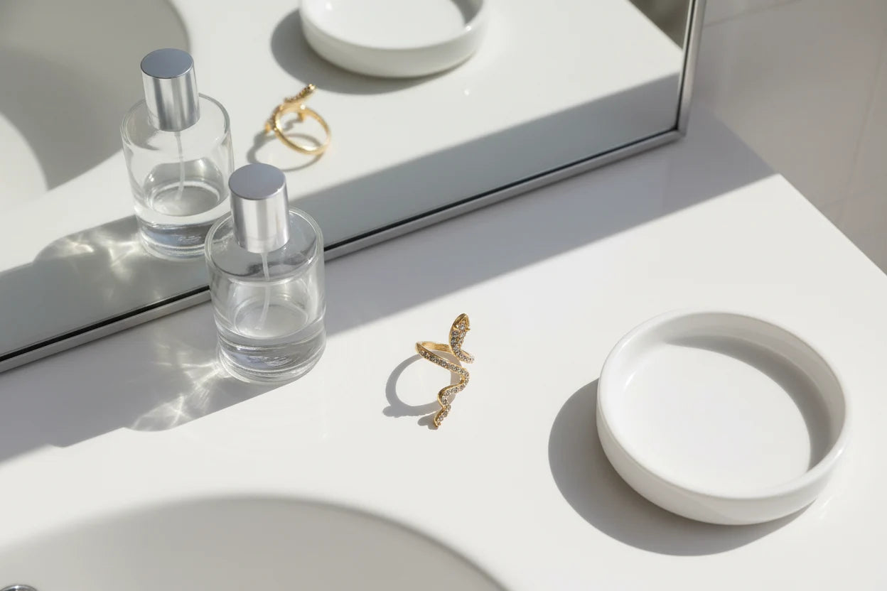 gold Pavé snake wrap ring on a bathroom vanity near a mirror and glass perfume bottles | OriaJewel