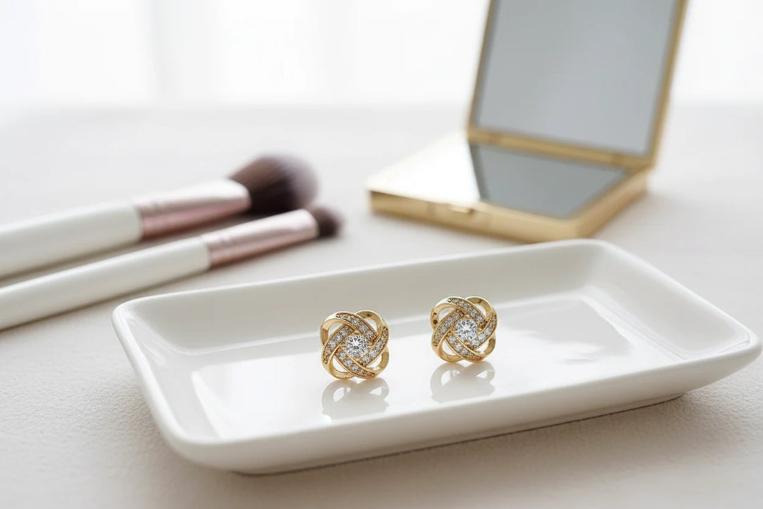 Gold Tone Knot Halo Stud Earrings on vanity tray with makeup brushes | OriaJewel