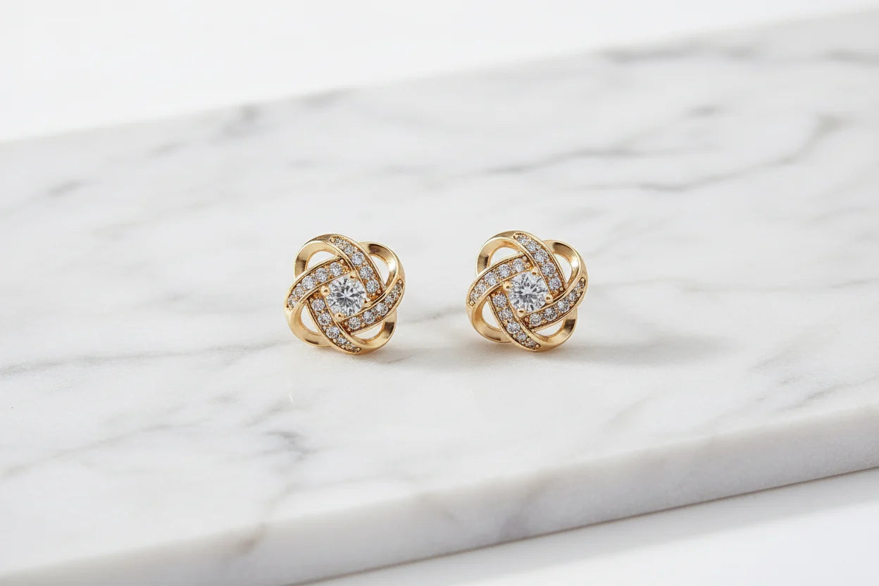 Gold Tone Knot Halo Stud Earrings close-up on marble surface | OriaJewel