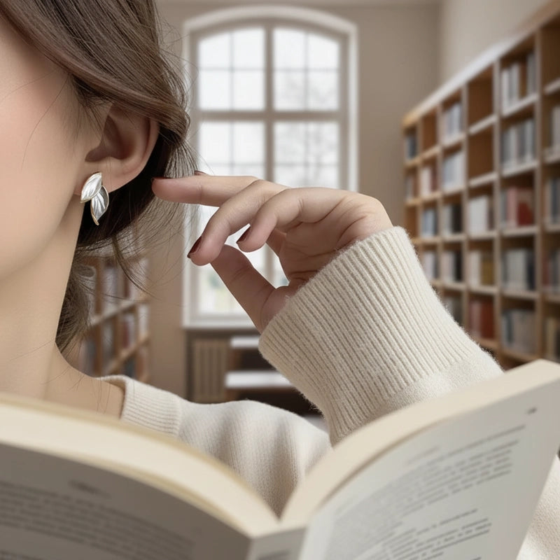 Gray Double Leaf Stud Earrings on model reading in library close-up | OriaJewel