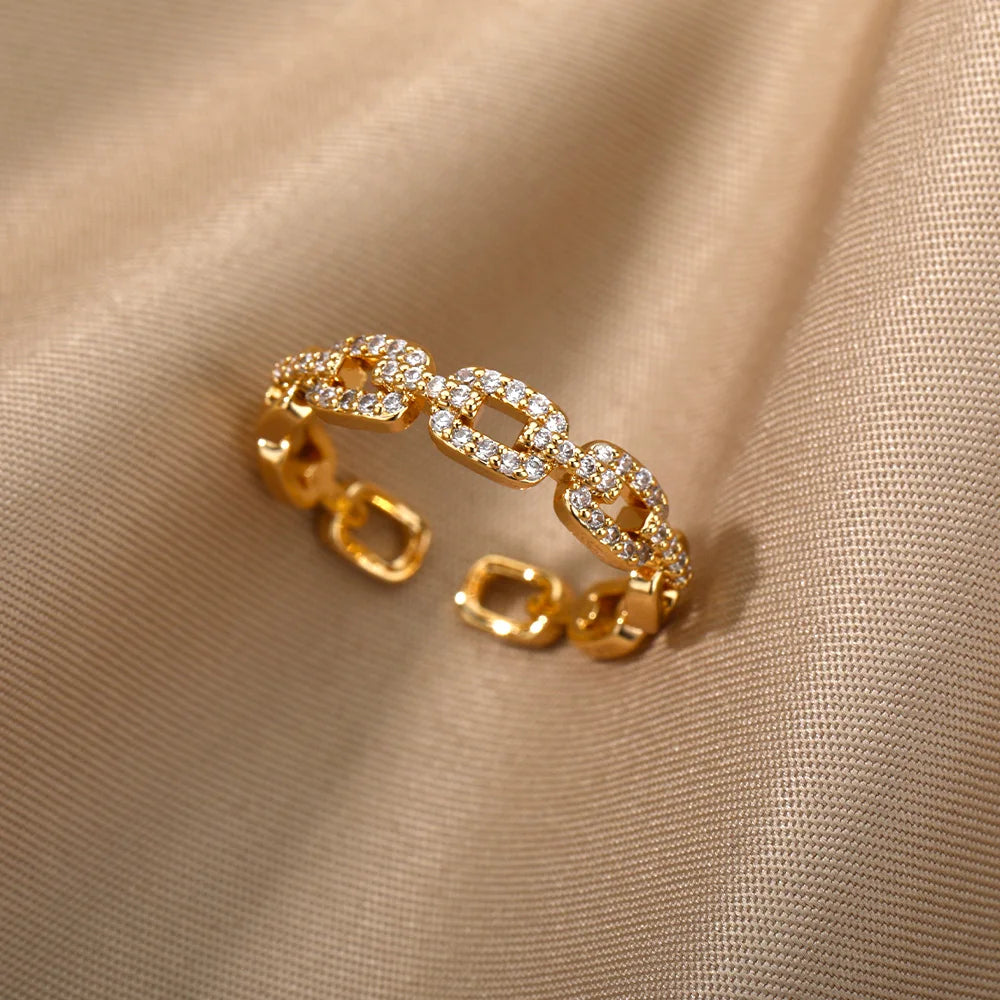 Glistening gold Crystal Link Chain Ring with clear crystals on draped satin fabric | Oria Jewel