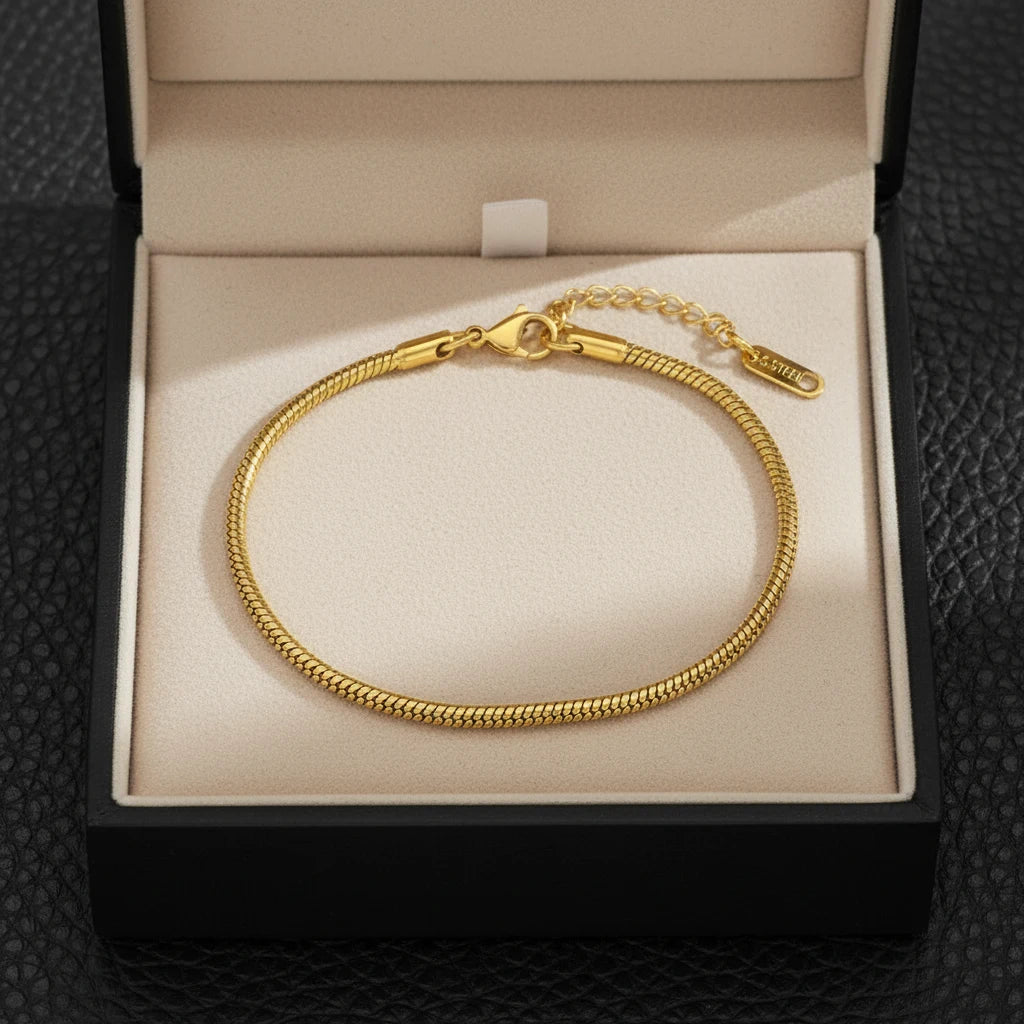 Gift-ready Minimalist Gold Chain Bracelet displayed in an elegant cream jewelry box on textured black surface | Oria Jewel