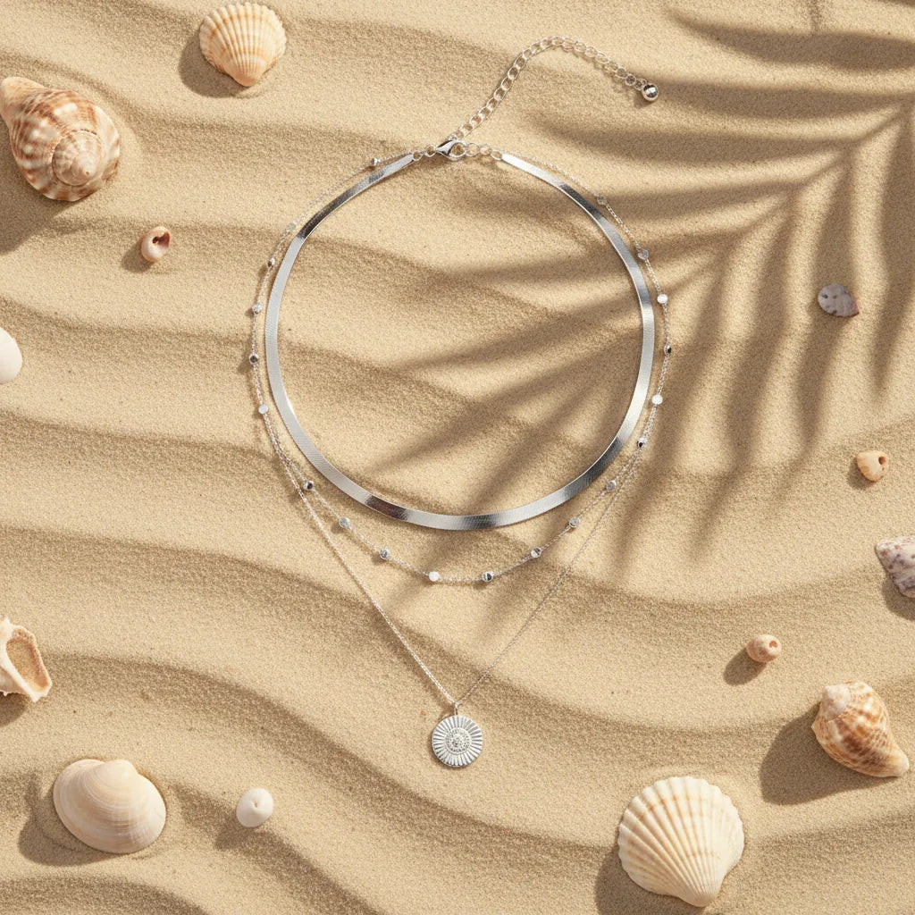 Multi Layer Silver Circle Chain Necklace displayed on sand among seashells under soft sunlight | Oria Jewel