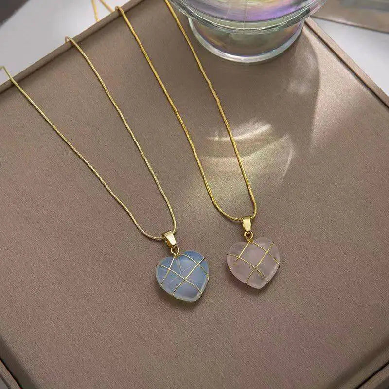 Two gold chains with blue and pink heart-shaped Natural Moonstone Pendants on tray | Oria Jewel