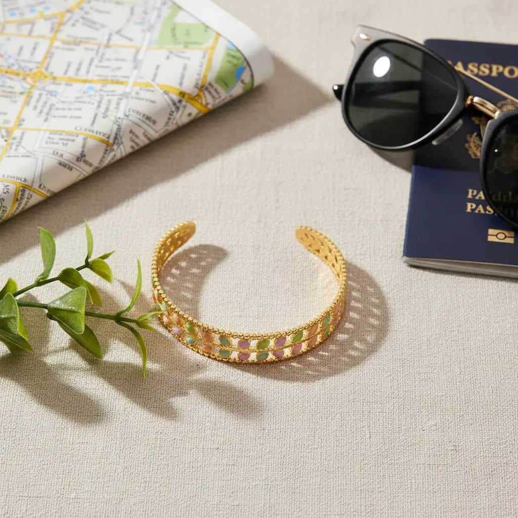 Travel-themed flat lay featuring the Pastel Leaf Garden Cuff Bracelet beside a folded city map, sunglasses and greenery on a linen surface, emphasizing the bracelet as a colorful vacation jewelry essential | Oria Jewel