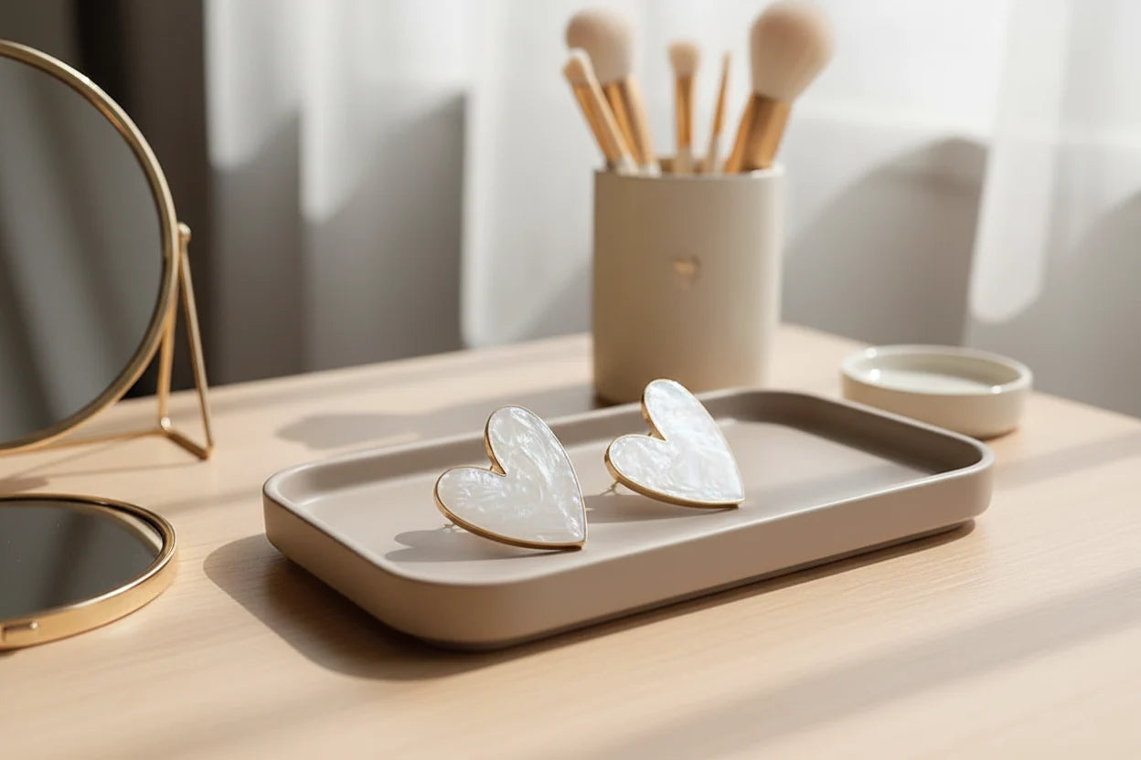 Pearl White Marble Heart Stud Earrings on vanity tray with mirror and brushes | OriaJewel