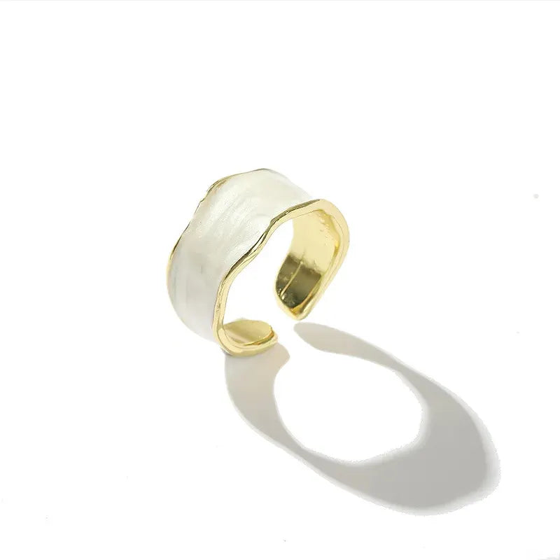 Pearl White Open Wave Ring product-only shot on a clean white background with a crisp shadow, featuring the open cuff shape, pearl-white enamel surface, and gold-tone lining | OriaJewel