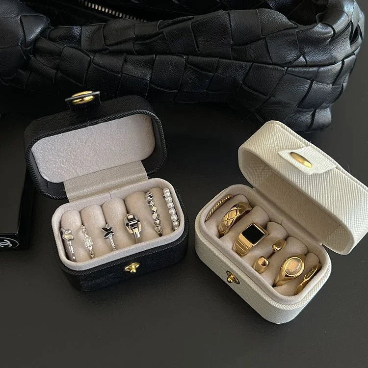 Open small portable jewelry box showing rings and earrings neatly stored | Oria Jewel
