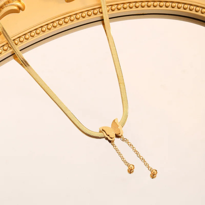 Close-up of Gold Butterfly Chain Necklace shining under soft light | Oria Jewel