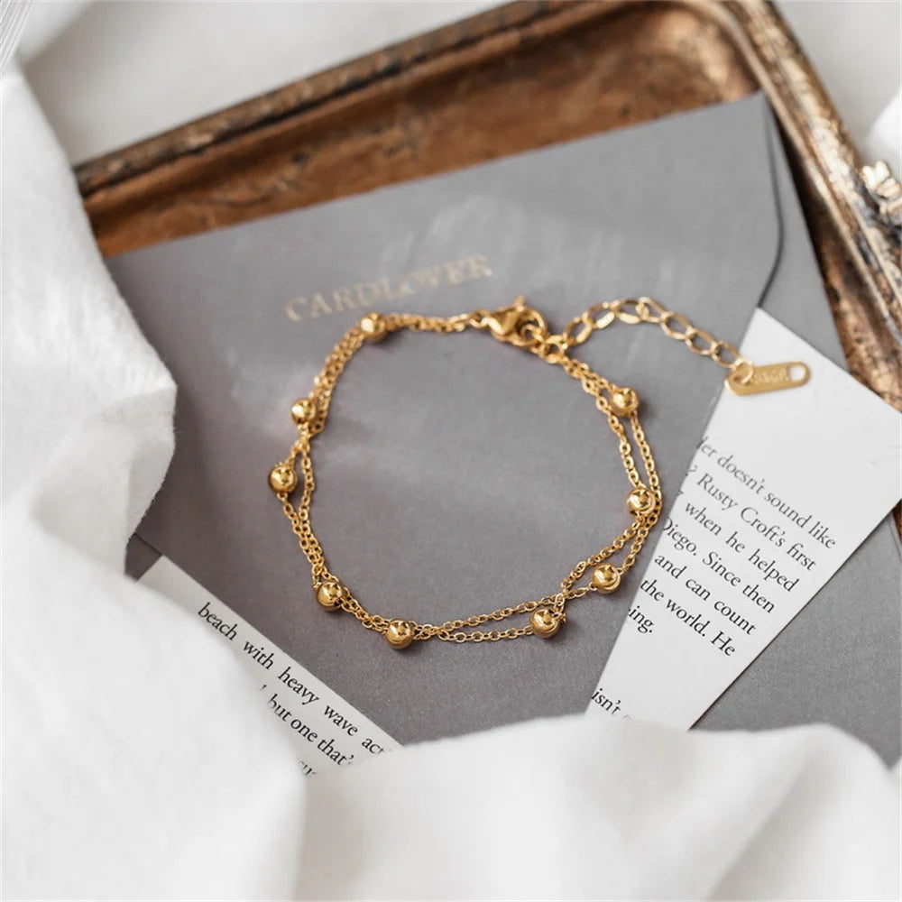 gold dangle anklet shining in sunlight on ankle | Oria Jewel