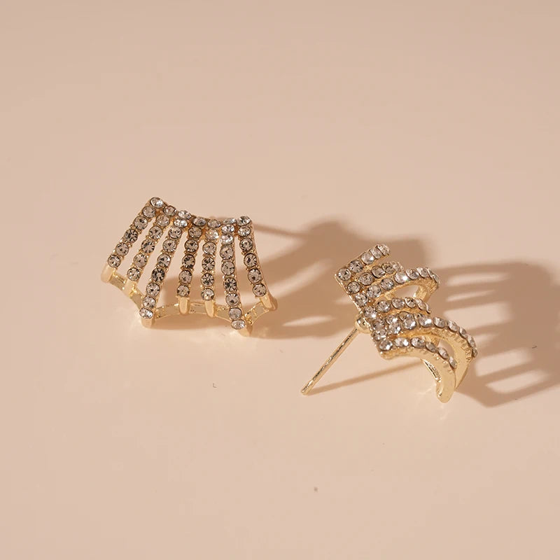 Delicate Rhinestone Stud Earrings, one fan-shaped, one wavy, on a light surface | Oria Jewel