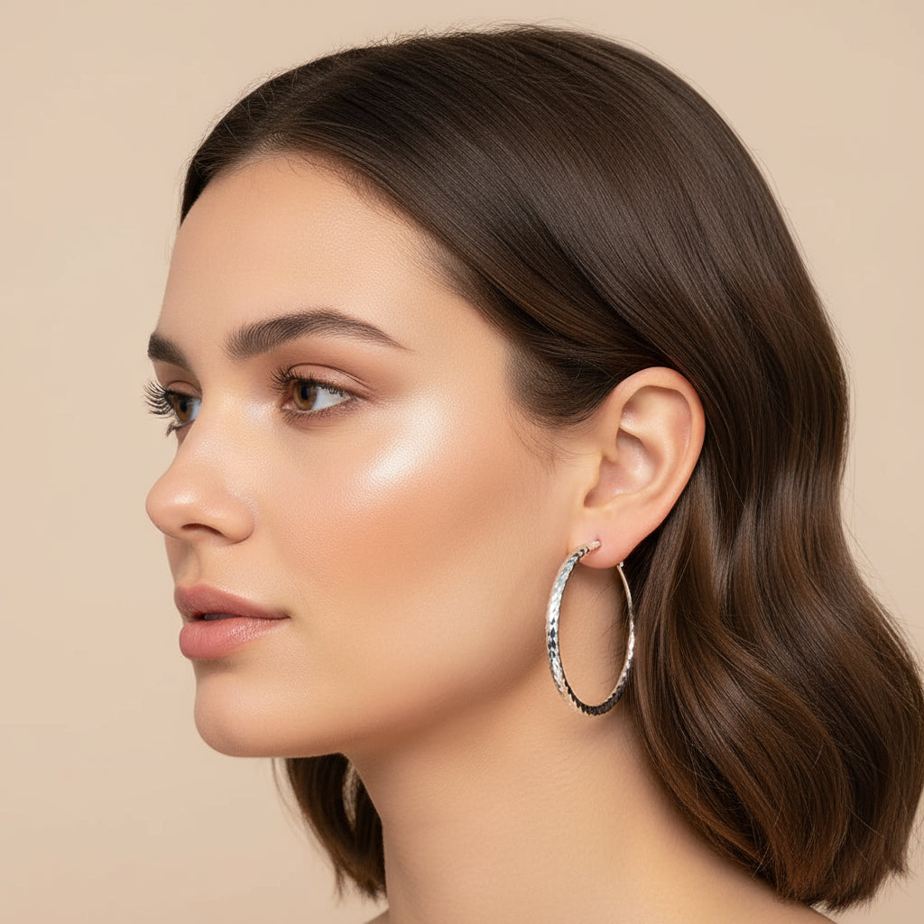 Silver Hoop Earrings showcased on a model with wavy hair, highlighting their elegance and shine.