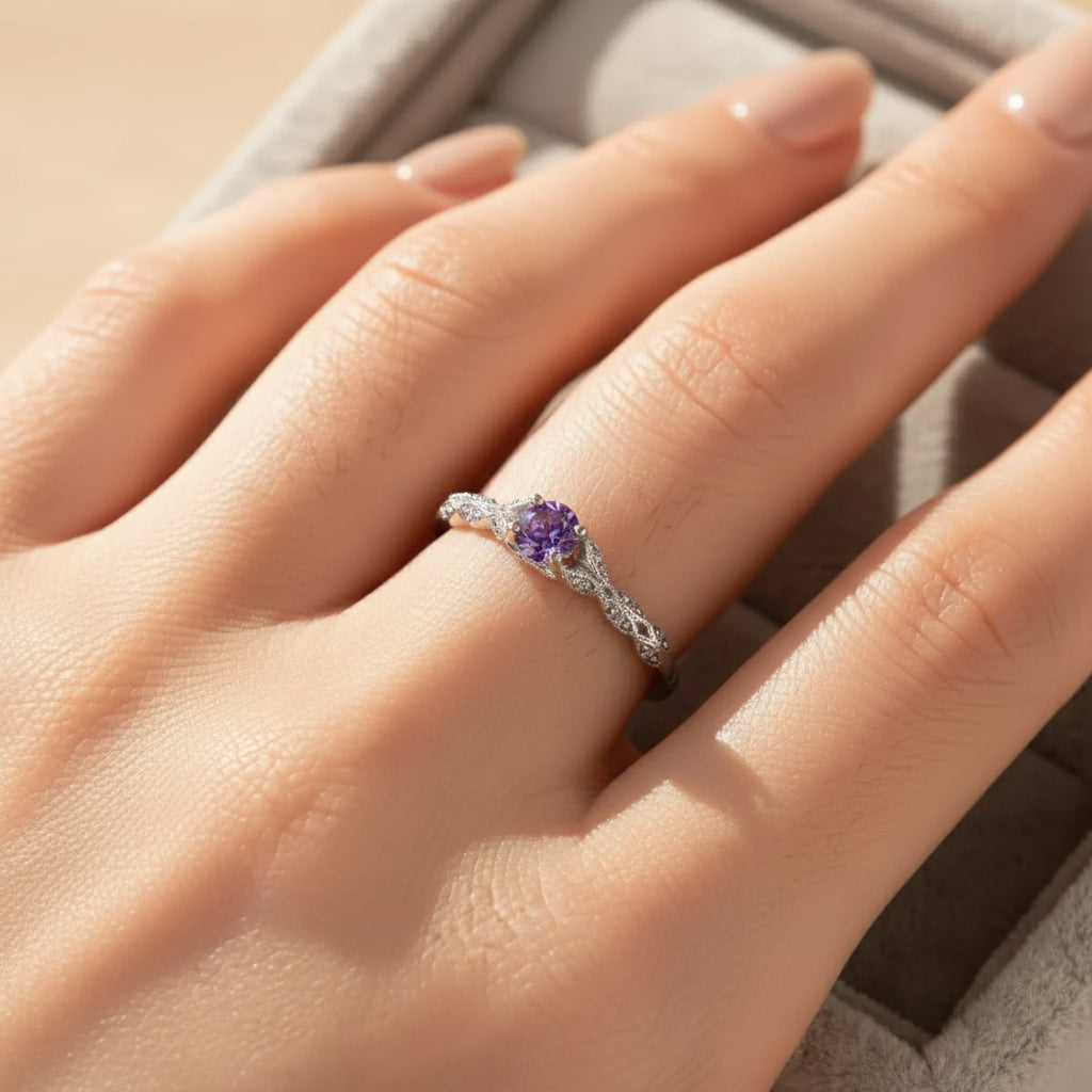 Violet Whisper Gemstone Ring displayed on a hand, featuring a purple gemstone and intricate band design | Oria Jewel