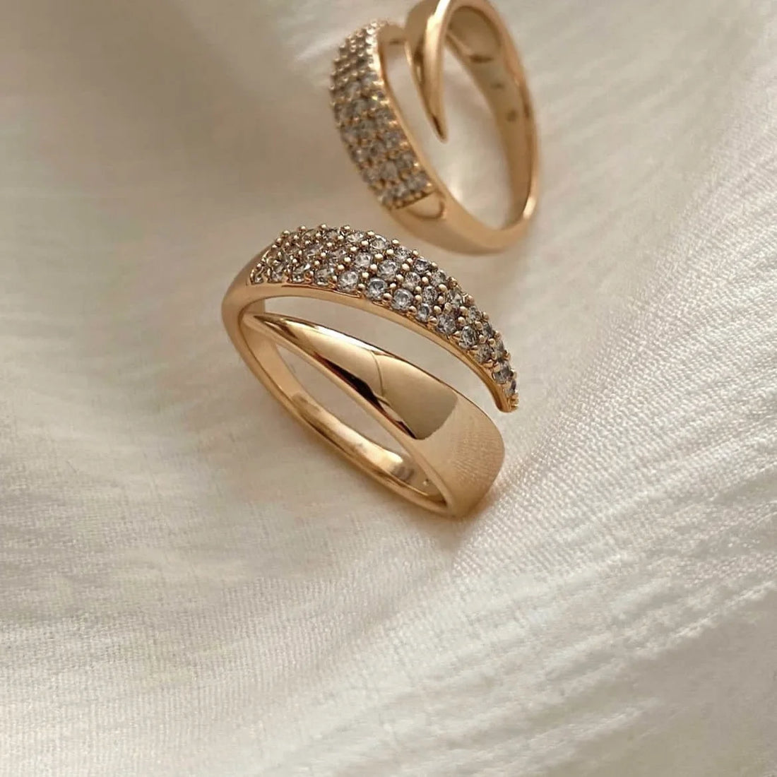 Close-up: a bypass Golden Rock Crystal Ring with pave detail on white fabric | Oria Jewel