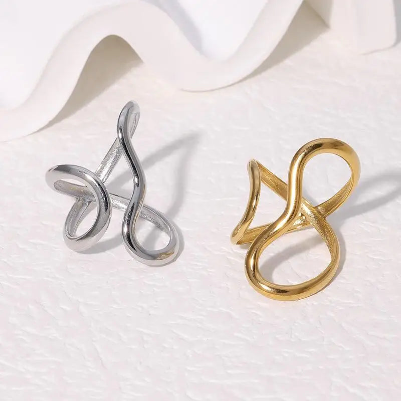 Modern Flow Gold Ring displayed alongside a silver ring, showcasing their elegant intertwined design | Oria Jewel