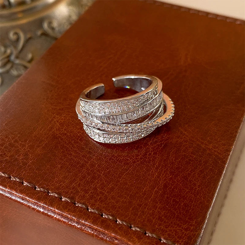 Sparkling Infinity Baguette Silver Ring on a textured brown surface with stitching | Oria Jewel
