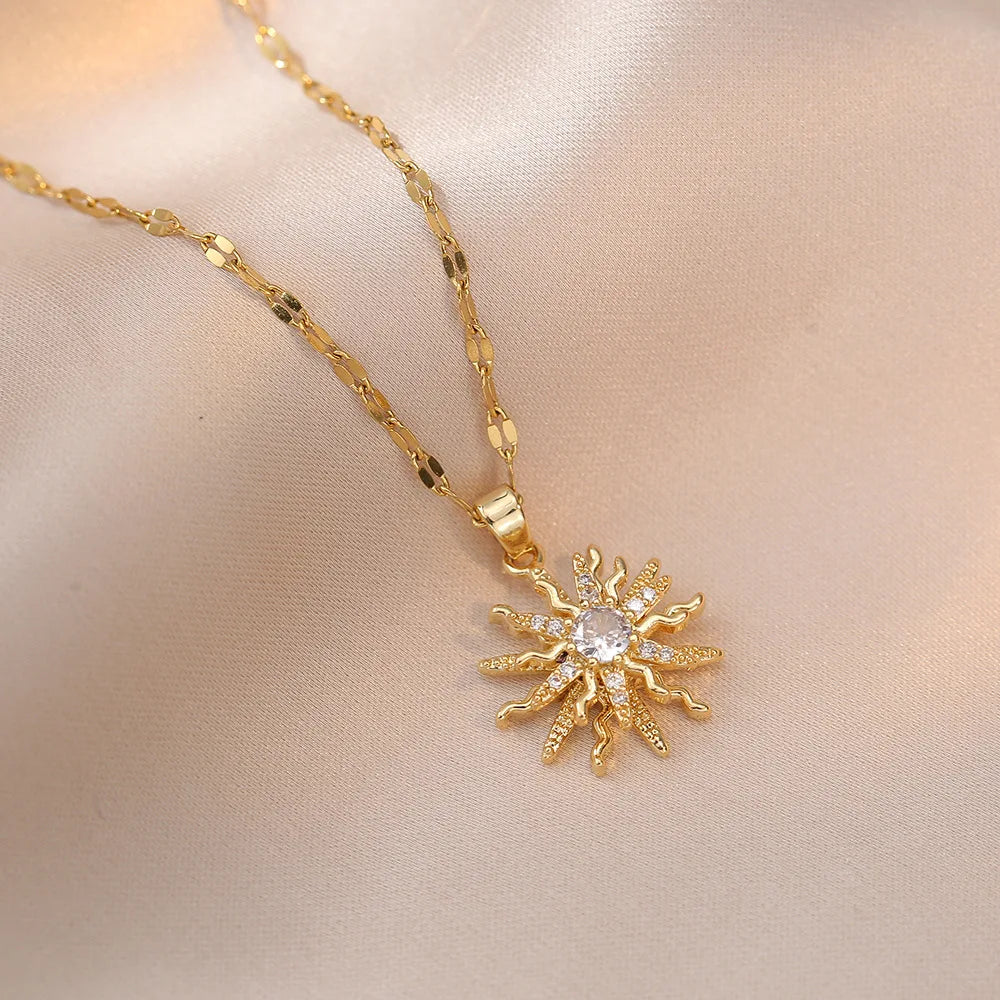Romantic flat lay of gold pendant rose flower jewelry with roses and sunlight | Oria Jewel