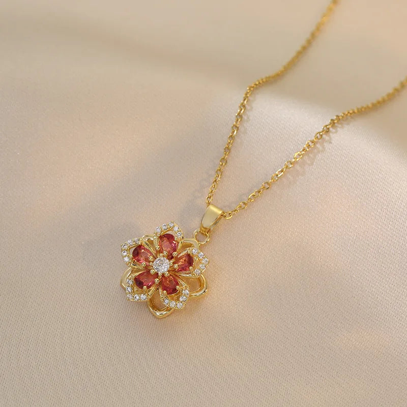Romantic flat lay of gold pendant rose flower jewelry with roses and sunlight | Oria Jewel