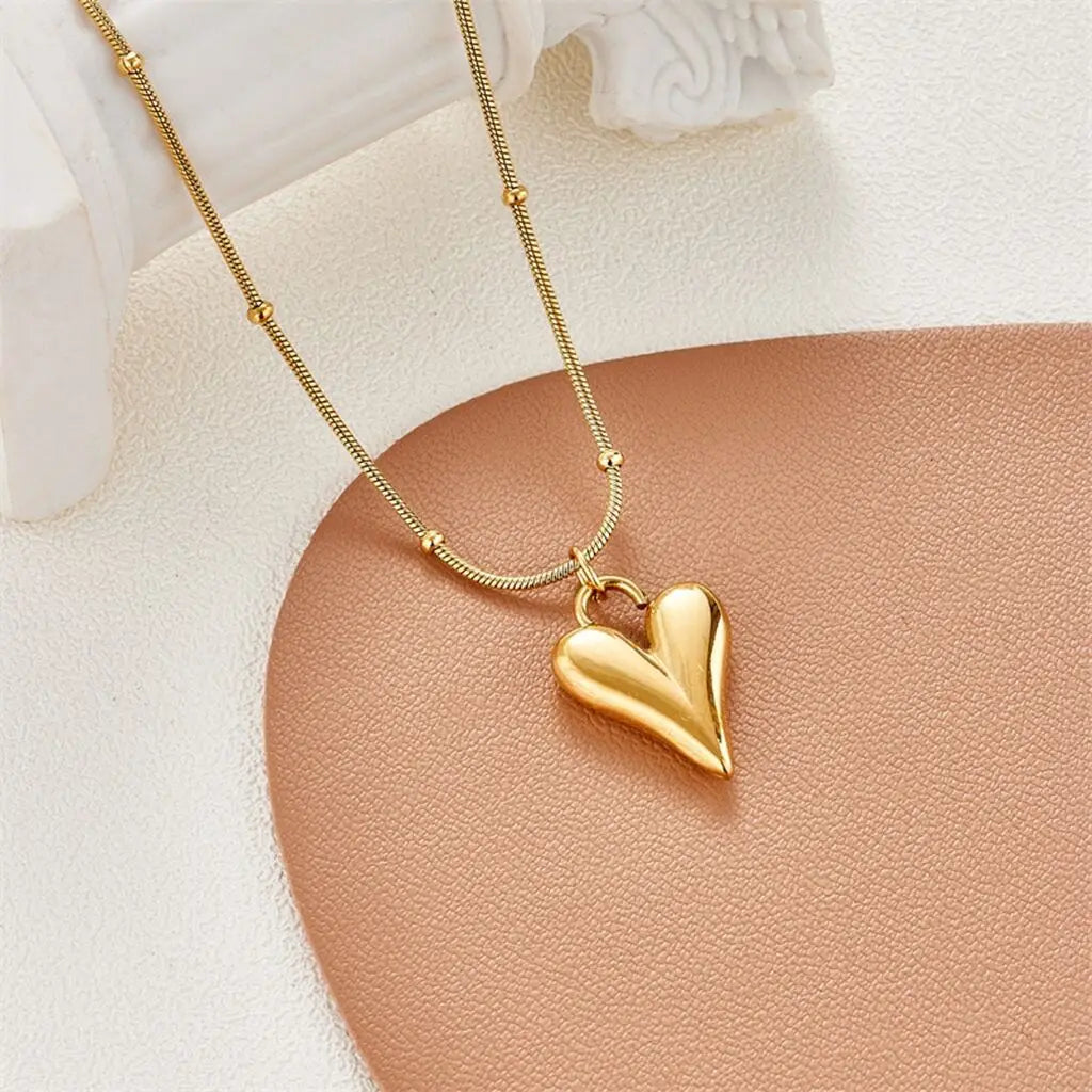 Close-up of love heart pendant necklace showing smooth, polished surface | Oria Jewel