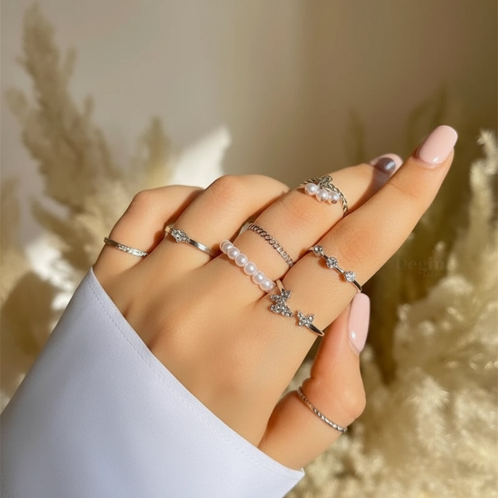 Silver Butterfly & Pearl Stacking Ring Set sparkling on a hand in soft light | Oria Jewel