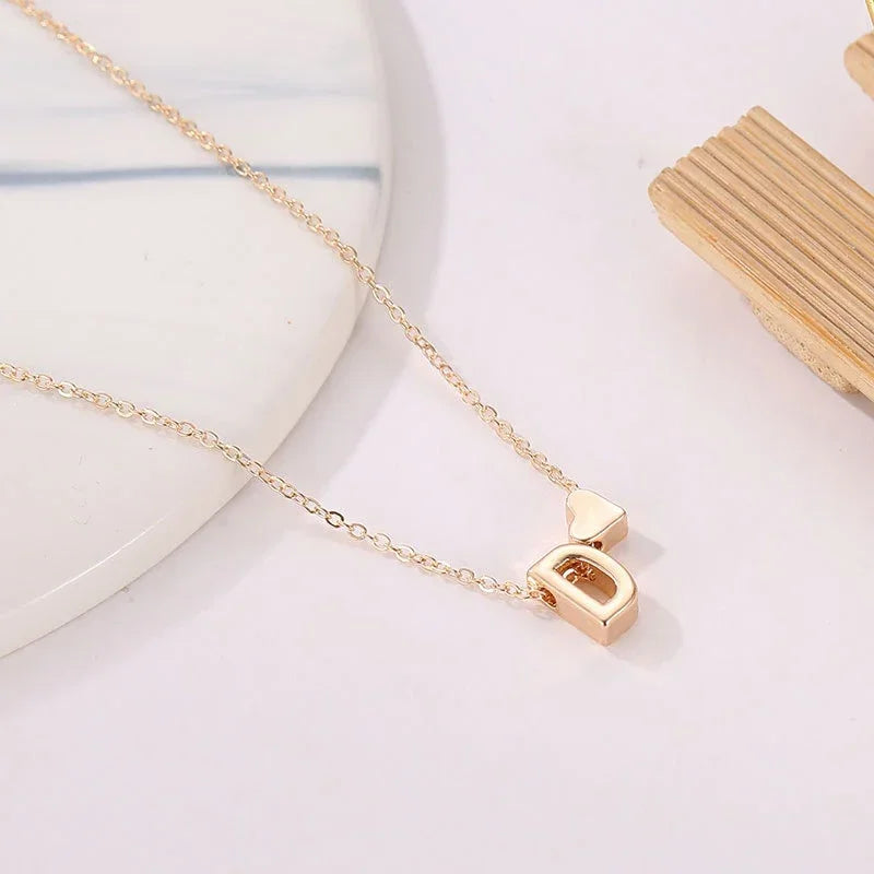 close-up of personalised heart necklace gold pendant with engraved name | Oria Jewel