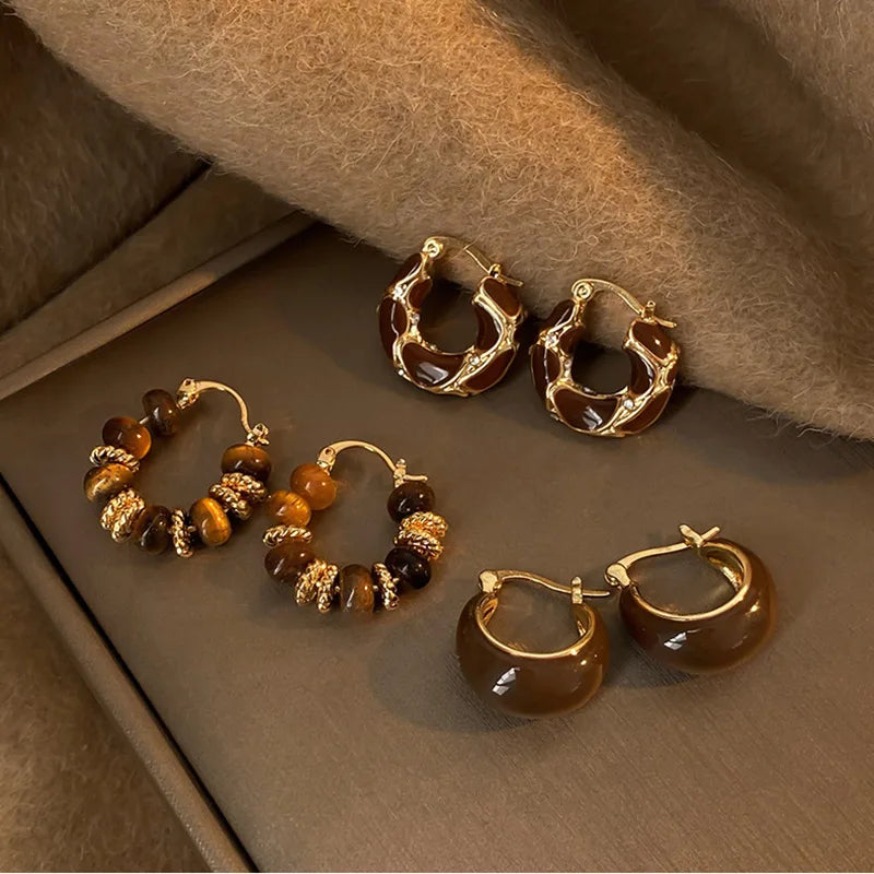 Beaded Tiger Eye Hoop Earrings and two other styles displayed on brown background | Oria Jewel