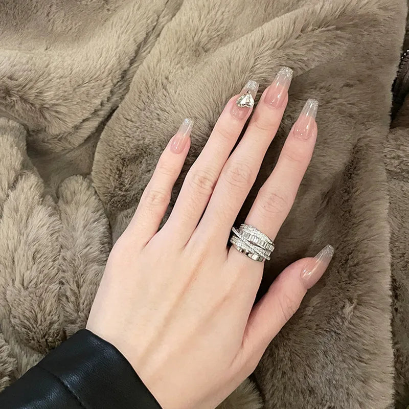 Close-up of a hand wearing an Infinity Baguette Silver Ring, showcasing elegant silver design on a fur background | Oria Jewel