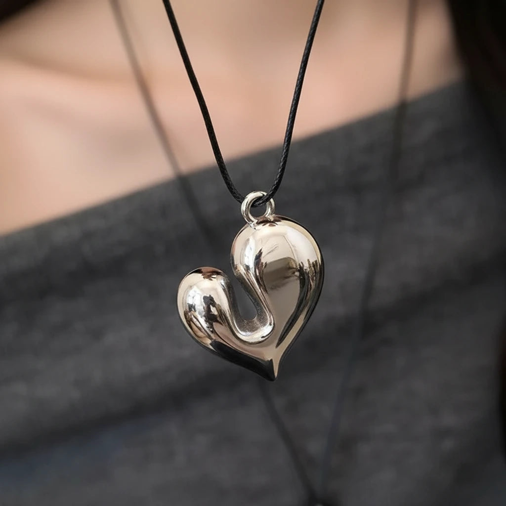 Simple Heart Pendant Necklace showcased on a model, featuring a shiny heart-shaped pendant on a black cord | Oria Jewel