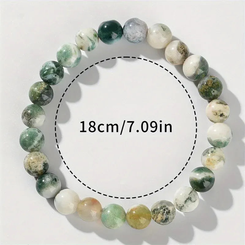 Close-up top view of an 18cm round beaded Success Energy Stone Bracelet on a white background with measurement text showing 7.09 inch wrist size, highlighting the natural green and white stones | Oria Jewel