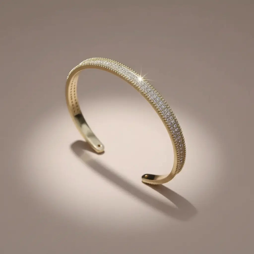 Studio close-up of the gold Xaria Pavé Wrist Cuff standing upright, its three rows of shimmering pavé crystals catching the light against a soft neutral backdrop | Oria Jewel