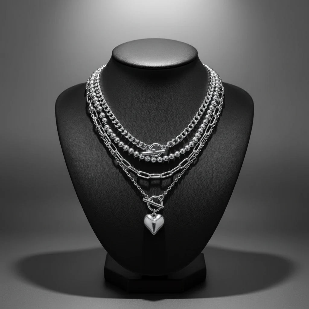 Y2K Heart Layered Necklace in silver styled on black display bust with metallic shine and bold layering | Oria Jewel
