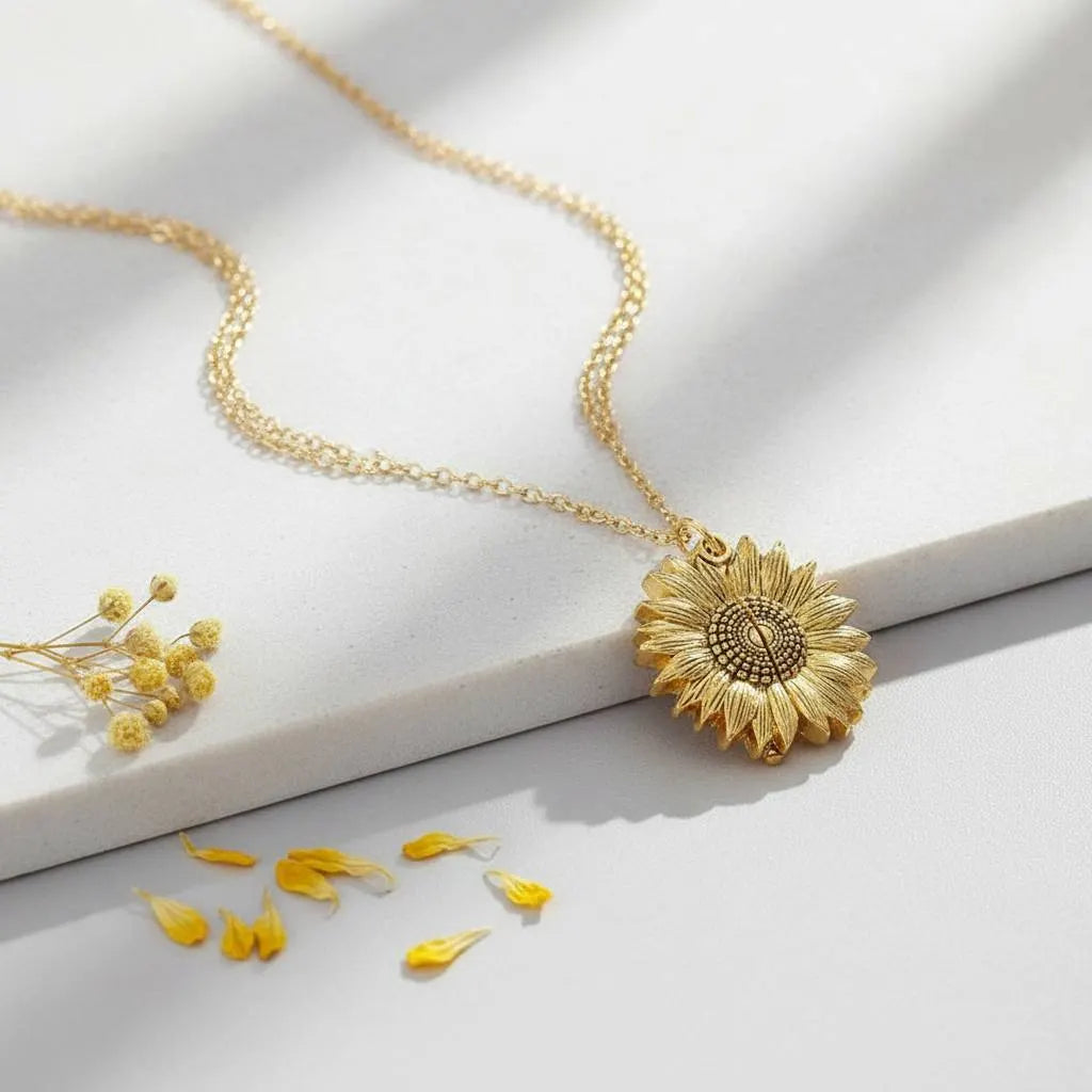 Close-up of You Are My Sunshine Sunflower Locket on marble with yellow petals | Oria Jewel