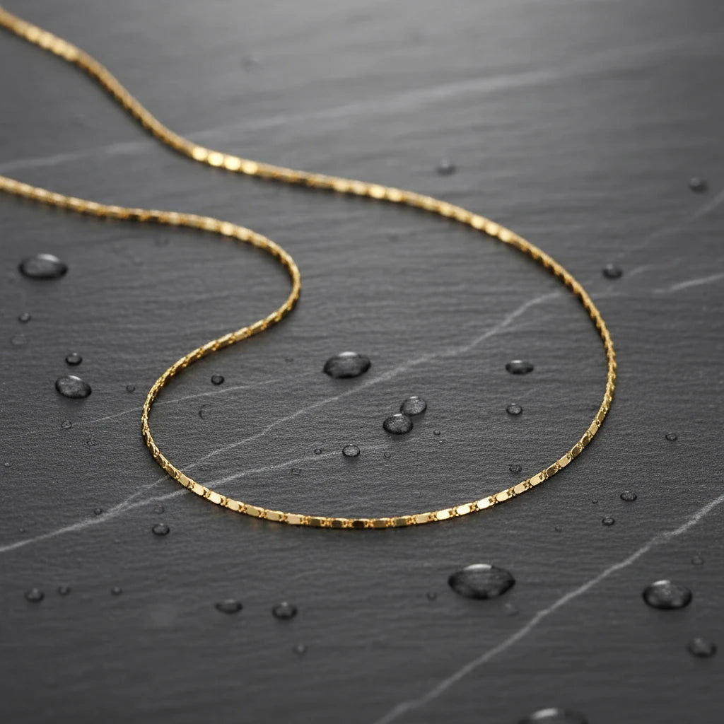 Water-resistant Flat Chain Choker displayed on dark stone surface with water droplets — durable and stylish | Oria Jewel