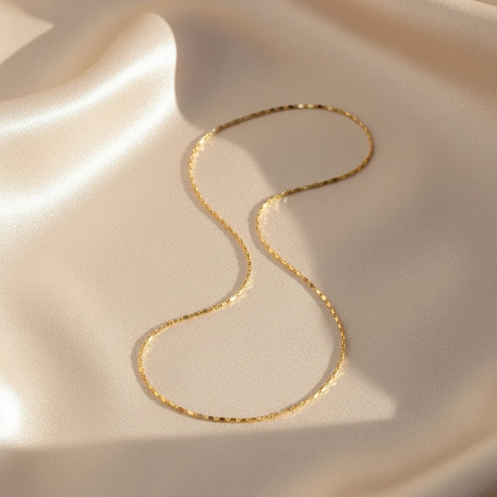 Minimalist Flat Chain Choker on smooth satin fabric — elegant gold shine with subtle texture | Oria Jewel